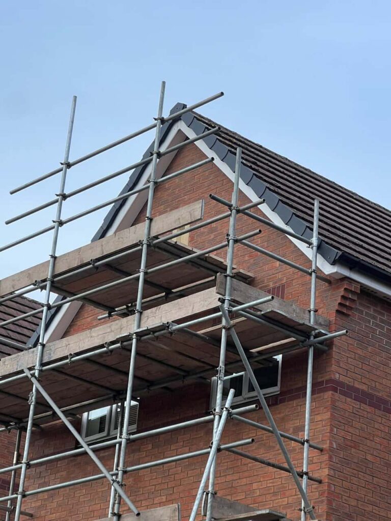 This is a photo of a roof which has just been repaired. There is a scaffold located at the gable end for access onto the roof. Works carried out by Chislehurst Roofing Repairs